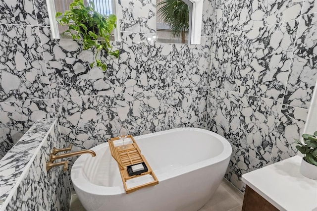 bathroom with a soaking tub and tile walls