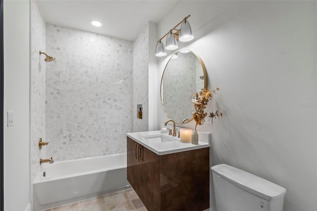 full bathroom with tile patterned floors, tiled shower / bath, toilet, and vanity