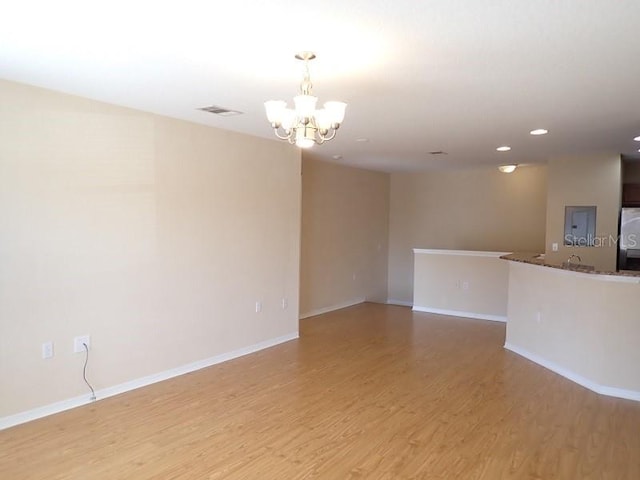 interior space with a chandelier and light wood-type flooring