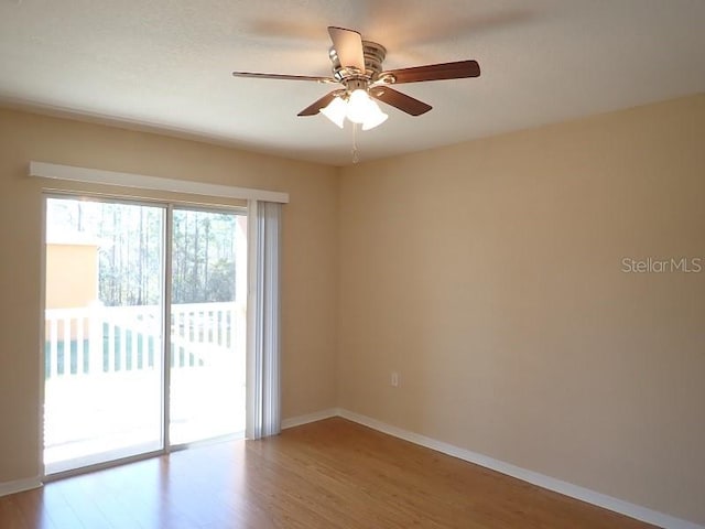 unfurnished room with ceiling fan and hardwood / wood-style floors