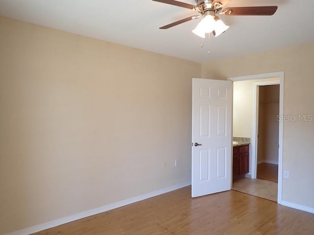 empty room featuring light hardwood / wood-style flooring and ceiling fan