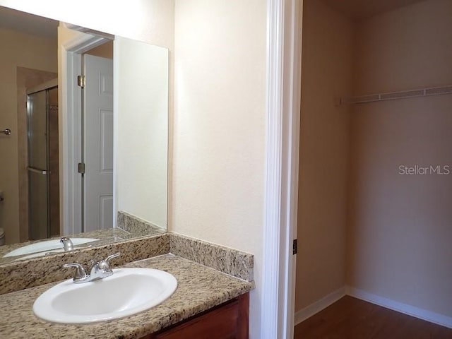 bathroom featuring toilet, hardwood / wood-style floors, and vanity