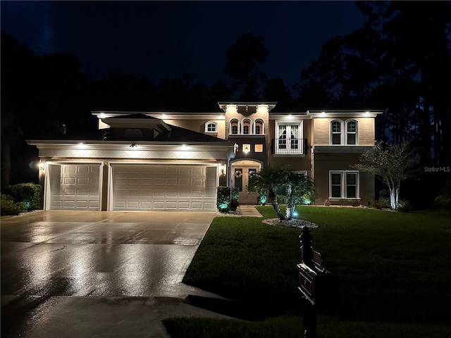 view of front facade with a garage and a yard