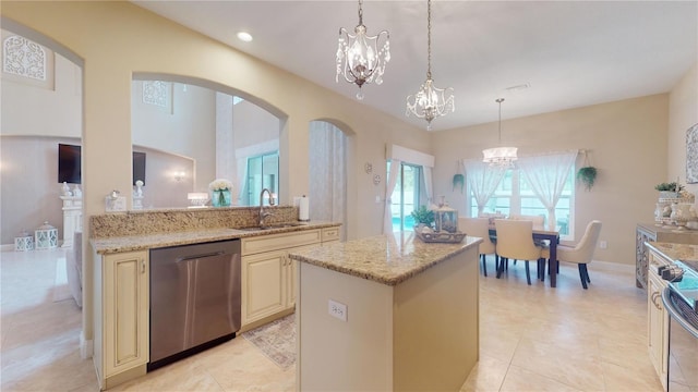 kitchen with light tile patterned floors, stainless steel dishwasher, sink, and light stone countertops