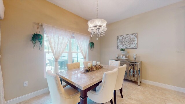 dining space featuring a notable chandelier and light tile patterned floors