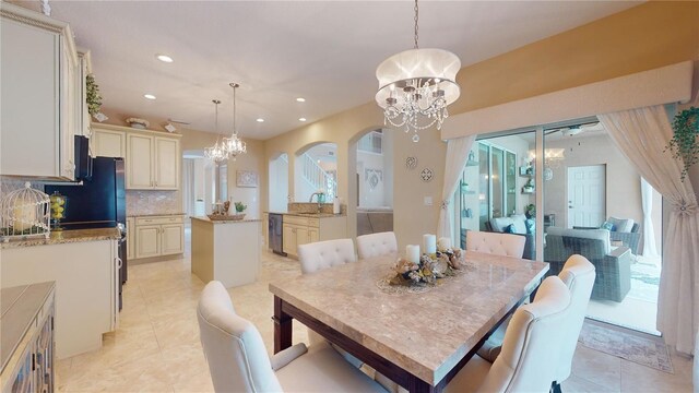 dining space featuring an inviting chandelier and light tile patterned floors