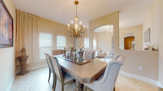 dining room featuring light tile patterned floors and an inviting chandelier