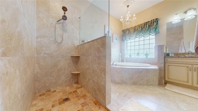 full bath with a notable chandelier, vanity, a walk in shower, tile patterned flooring, and a bath