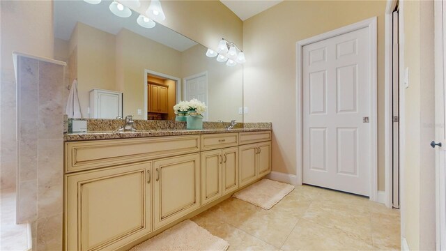 bathroom featuring tile patterned flooring and vanity