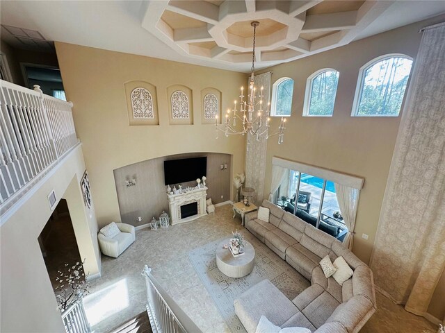 living room with a chandelier, a towering ceiling, and coffered ceiling