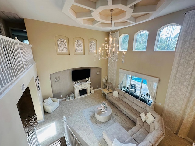 living room with a high ceiling, a fireplace, a chandelier, and coffered ceiling