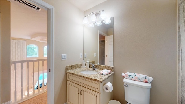 bathroom featuring visible vents, vanity, and toilet