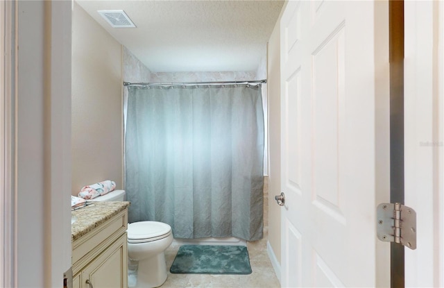 full bathroom featuring vanity, shower / bath combo with shower curtain, tile patterned floors, a textured ceiling, and toilet