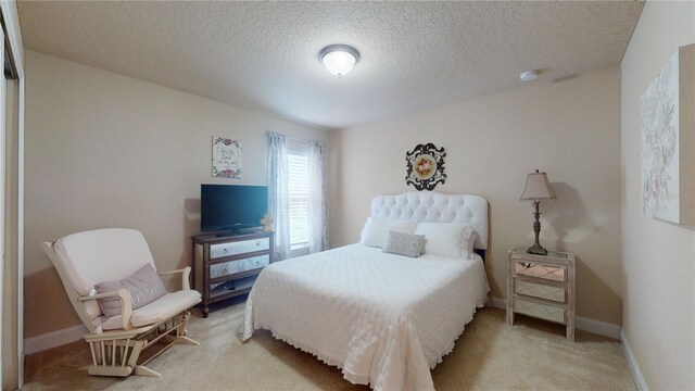 carpeted bedroom featuring a textured ceiling