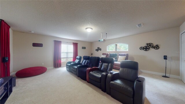 cinema room featuring a textured ceiling and carpet floors