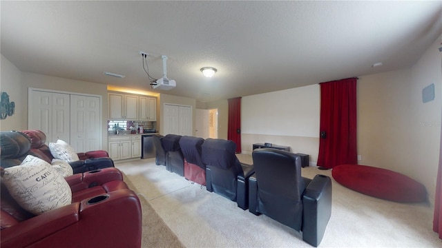 home theater room featuring light carpet and visible vents