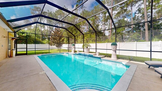 view of swimming pool with a patio and a lanai