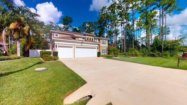 view of front of property featuring a front yard and a garage