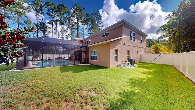 back of property with a lanai, a fenced backyard, central air condition unit, a lawn, and stucco siding