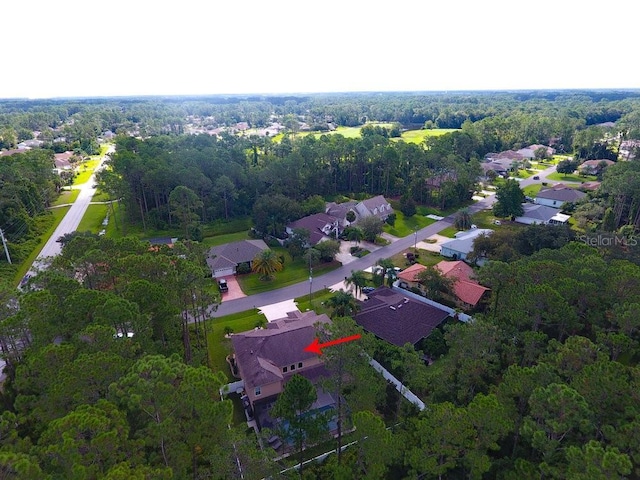 birds eye view of property with a residential view and a view of trees