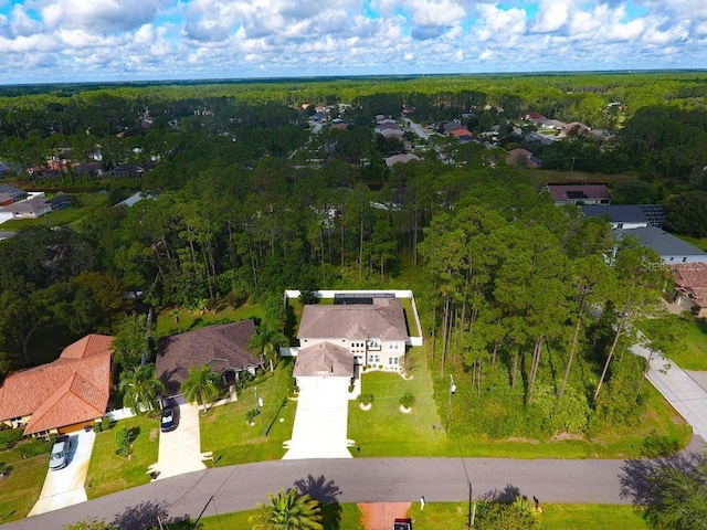 birds eye view of property with a forest view and a residential view