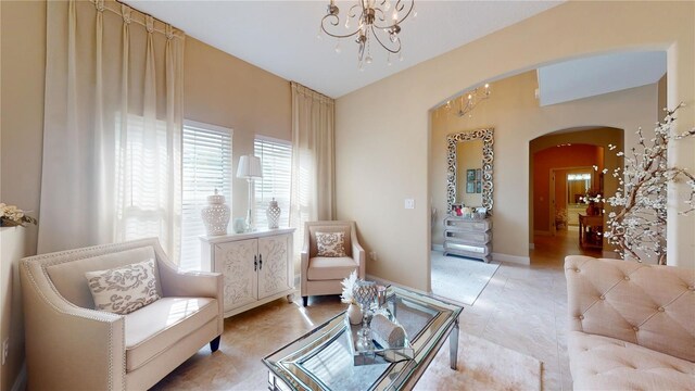 tiled living room featuring an inviting chandelier