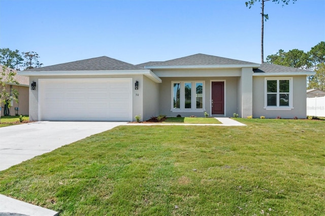 view of front of home featuring a garage and a front lawn