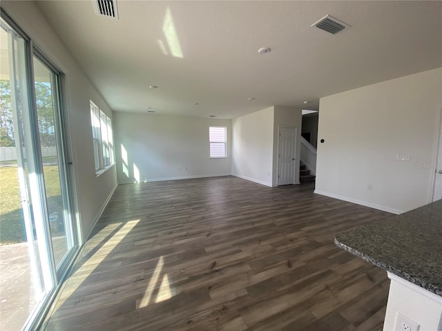 unfurnished living room with dark hardwood / wood-style floors