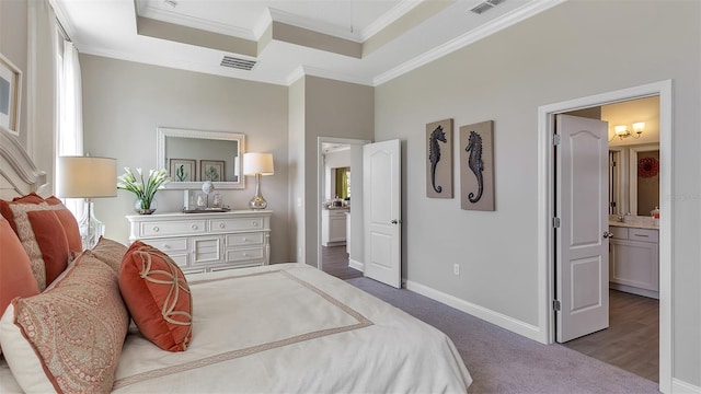 carpeted bedroom with baseboards, visible vents, ornamental molding, and a tray ceiling