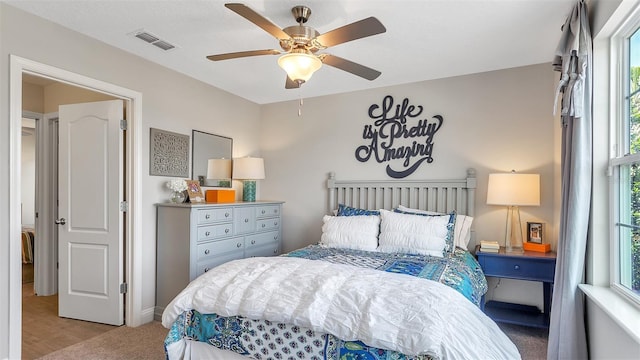 bedroom featuring ceiling fan, hardwood / wood-style floors, and multiple windows