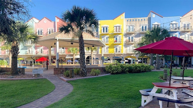 view of home's community with a lawn and a gazebo