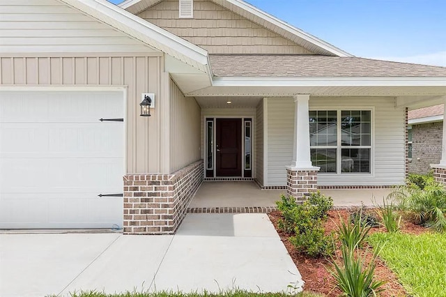 property entrance with covered porch and a garage