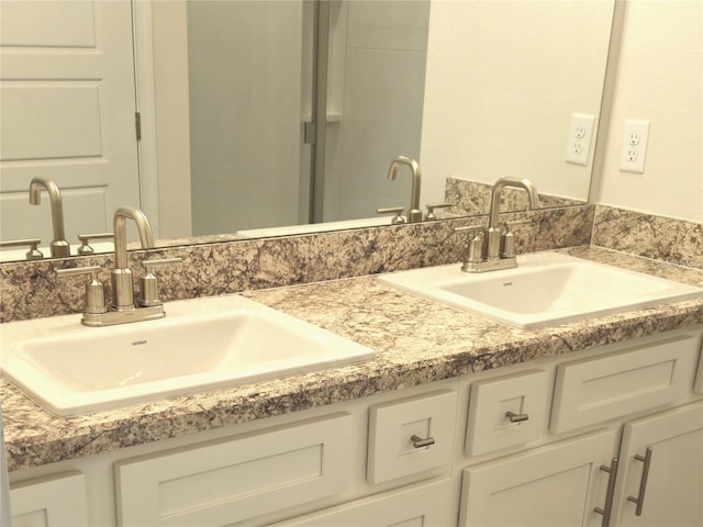 full bathroom featuring double vanity and a sink