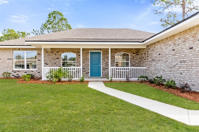 doorway to property featuring a lawn and a porch