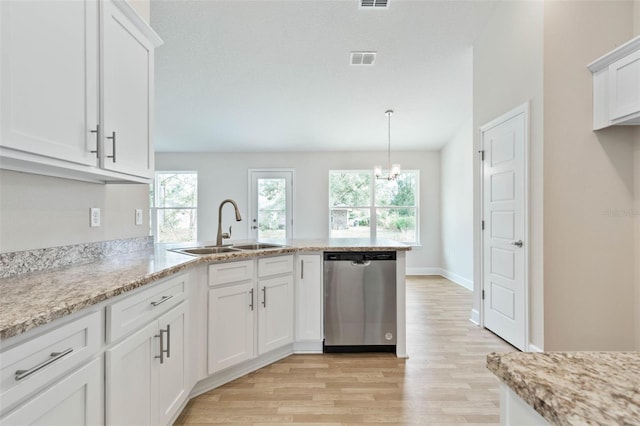 kitchen featuring light hardwood / wood-style floors, stainless steel dishwasher, sink, white cabinets, and kitchen peninsula