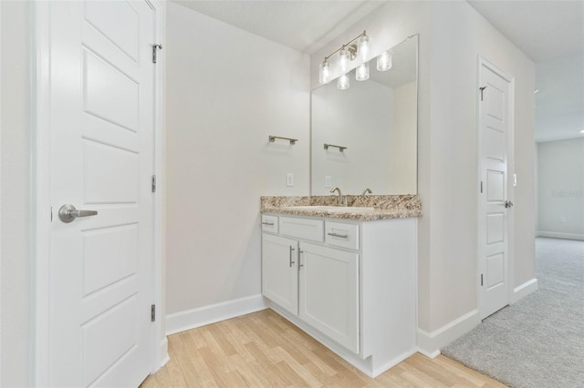 bathroom with hardwood / wood-style floors and vanity