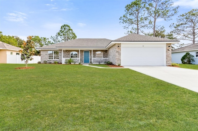 ranch-style home featuring a front yard, a garage, and covered porch