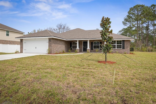 ranch-style home featuring a front lawn, driveway, fence, an attached garage, and brick siding