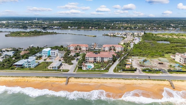 aerial view with a water view and a beach view