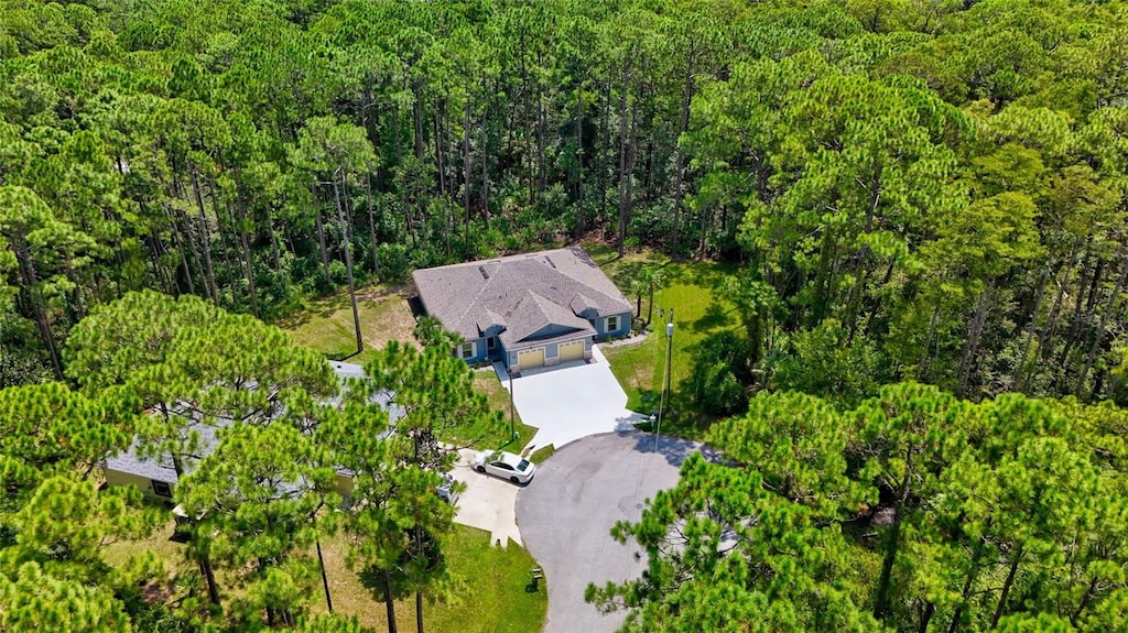 birds eye view of property with a forest view