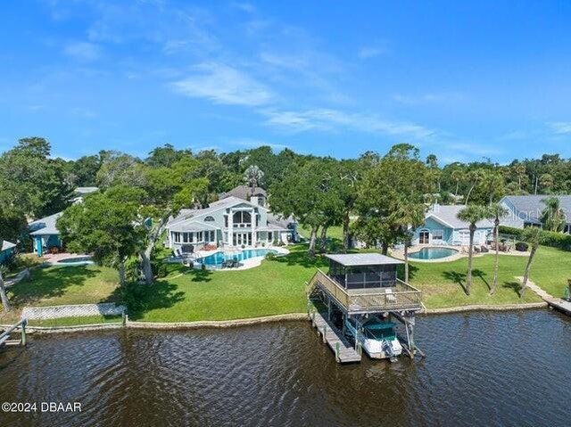 dock area with a water view and a yard