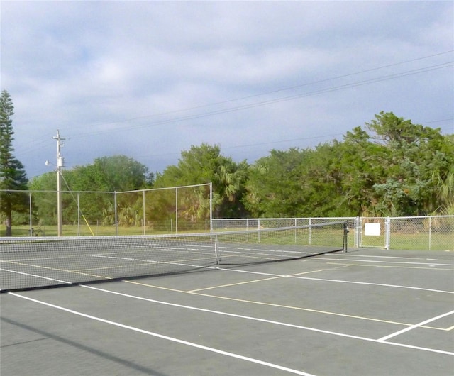 view of sport court featuring fence