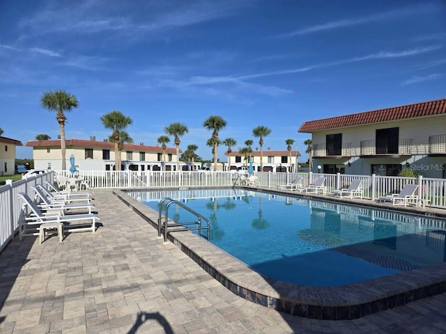 pool featuring a patio area and fence