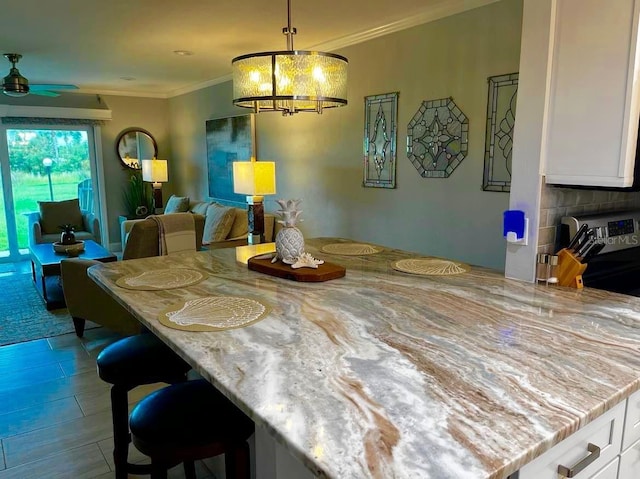 tiled dining space with crown molding and ceiling fan with notable chandelier