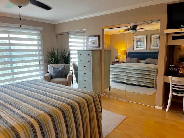 bedroom featuring ceiling fan, crown molding, and wood finished floors