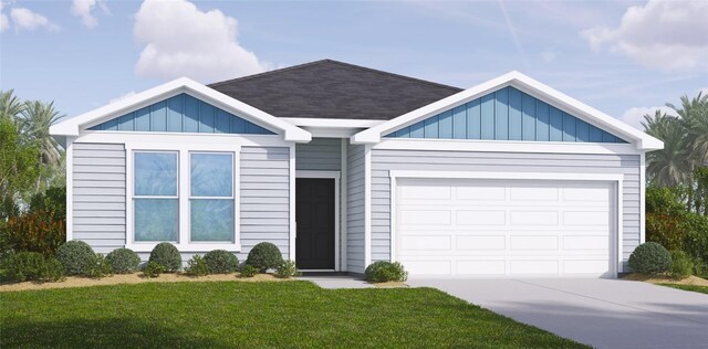 view of front of property with a front lawn and a garage