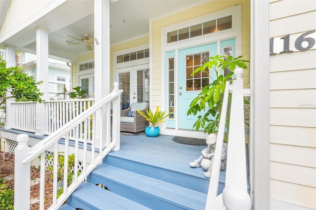 property entrance featuring covered porch and french doors