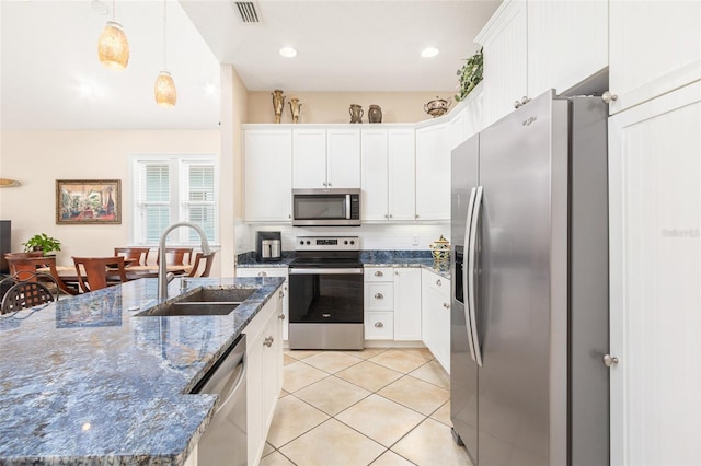 kitchen with light tile patterned floors, visible vents, appliances with stainless steel finishes, white cabinetry, and a sink