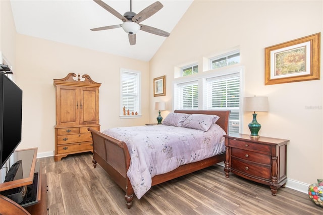 bedroom with high vaulted ceiling, light wood-type flooring, baseboards, and a ceiling fan