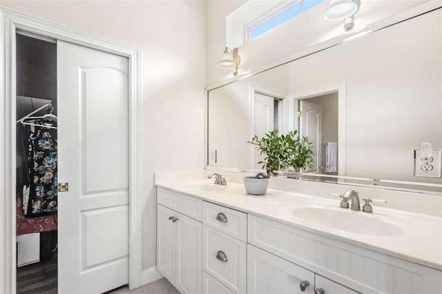 bathroom with a sink and double vanity